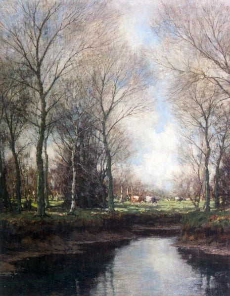 Cows Grazing Along a Stream